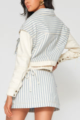 Back angle view of the Giani striped denim jacket showcasing the solid color cream contrast sleeves with adjustable drawstring tie details.