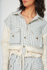 Front close up of the Giani Denim Jacket showing the chevron striped pattern on the bodice and two front utility flap pockets.
