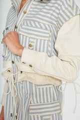 Detailed close up of the Giani denim jacket sleeve construction featuring heavy topstitching and a hanging cotton drawstring cord.