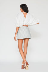 Back view of the Mati Denim Skirt showcasing blue stripe fabric, clean tailored fit, and flattering high waisted silhouette.