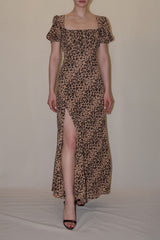 Full-length linesheet studio shot presenting the front silhouette of the leopard print Sandra dress, displaying its square neckline, fitted waist, and thigh-high front leg slit.