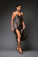 Full-length studio portrait of a woman wearing the printed paisley silk Linda slip dress, showcasing the high side leg slit, black lace trim neckline, and strappy sandals.