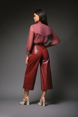 Rear studio perspective of a model showcasing the Western-style pointed back yoke, gathered fluid chiffon drape, and buttoned cuffs of the mauve pink Martha sheer blouse.