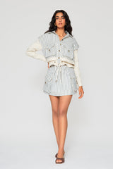 Full-length studio shot of the blue and white striped Giani jacket paired with the matching Mati cargo pocket skirt and brown slides.