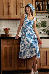Model standing up, wearing the Cindy Castro New York Jessica blue floral midi dress with matching headscarf.