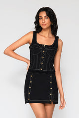 Close-up studio shot emphasizing the front panel design of the black Leslie denim bustier, featuring a button-down center placket and structured, white-stitched corset lines.