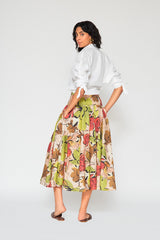 Rear studio perspective of a model showcasing the voluminous flared profile, high-waisted fit, and seamless floral pattern continuity on the back of the Patricia long skirt.