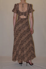 Rear studio linesheet perspective of the leopard print Sandra maxi dress, highlighting its unique back cutout design with a delicate top tie closure.