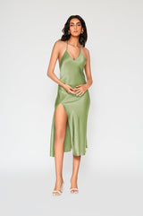 Vanessa Slip Dress in kiwi green satin featuring delicate spaghetti straps, bias cut silhouette, thigh high slit, and fluid movement.